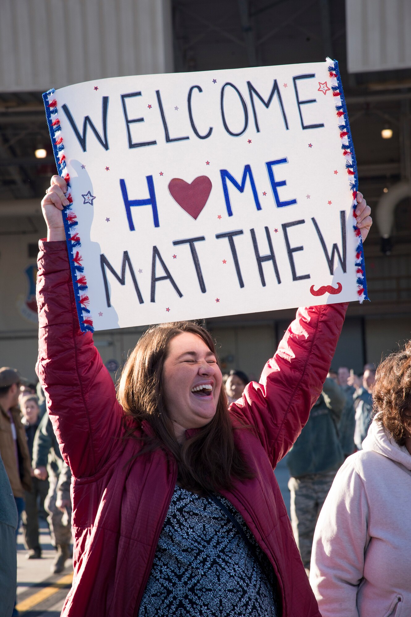 Sara, wife of Maj. Matthew “Chowder” Cichowski, 74th Fighter Squadron (FS) A-10C Thunderbolt II pilot, cheers during a redeployment ceremony, Jan. 19, 2018, at Moody Air Force Base, Ga. During the seven-month deployment, the 74th FS flew more than 1,700 sorties, employed weapons over 4,400 times, destroyed 2,300 targets and killed 2,800 ISIS insurgents. (U.S. Air Force photo by Andrea Jenkins)