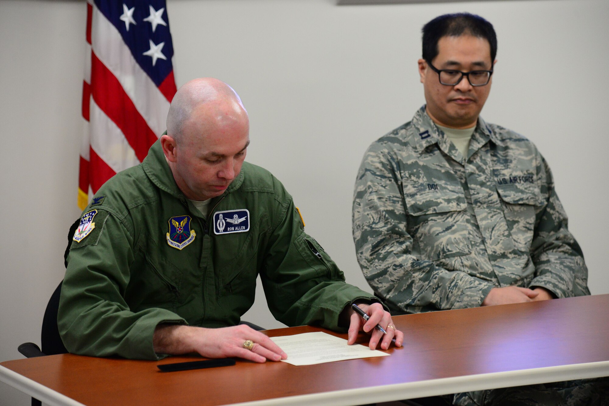Col. Ronald Allen, 341st Missile Wing commander, left, signs a proclamation for Biomedical Sciences Corps Appreciation Week Jan. 19, 2018, at Malmstrom Air Force Base, Mont.