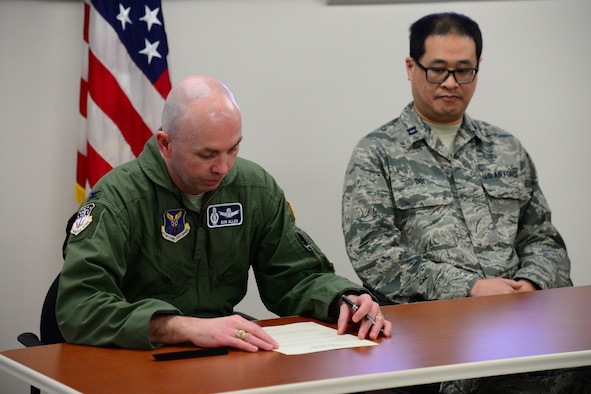 Col. Ronald Allen, 341st Missile Wing commander, left, signs a proclamation for Biomedical Sciences Corps Appreciation Week Jan. 19, 2018, at Malmstrom Air Force Base, Mont.