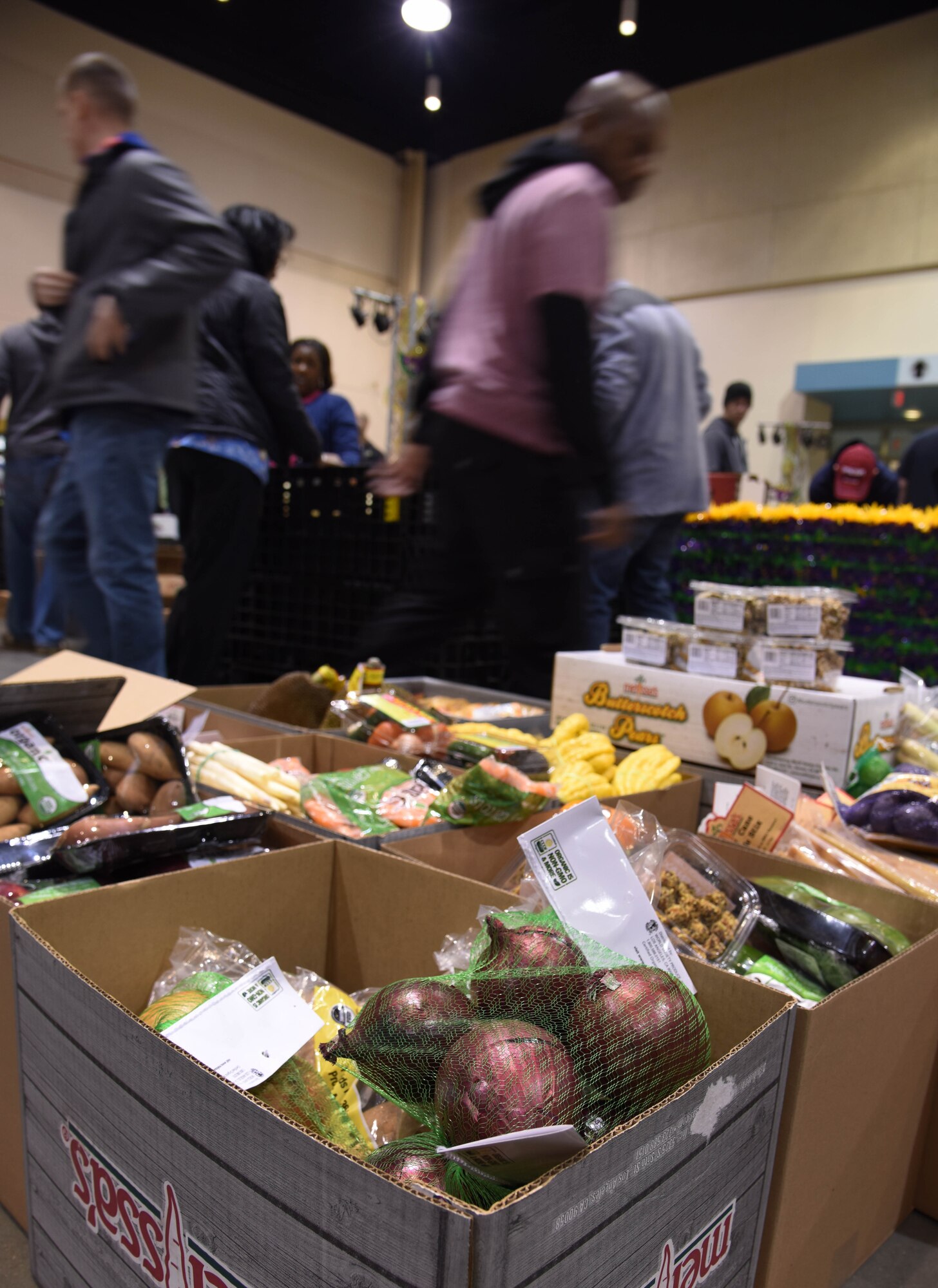 Food items sit in boxes during a food drive at the Mississippi Coast Coliseum and Convention Center Jan. 16, 2018, Biloxi, Mississippi. More than 80 Airmen participated in the wing-level community sponsored volunteer event packaging over 21,000 pounds of food, equating to approximately 17,500 meals that will be provided to hunger relief. (U.S. Air Force photo by Kemberly Groue)