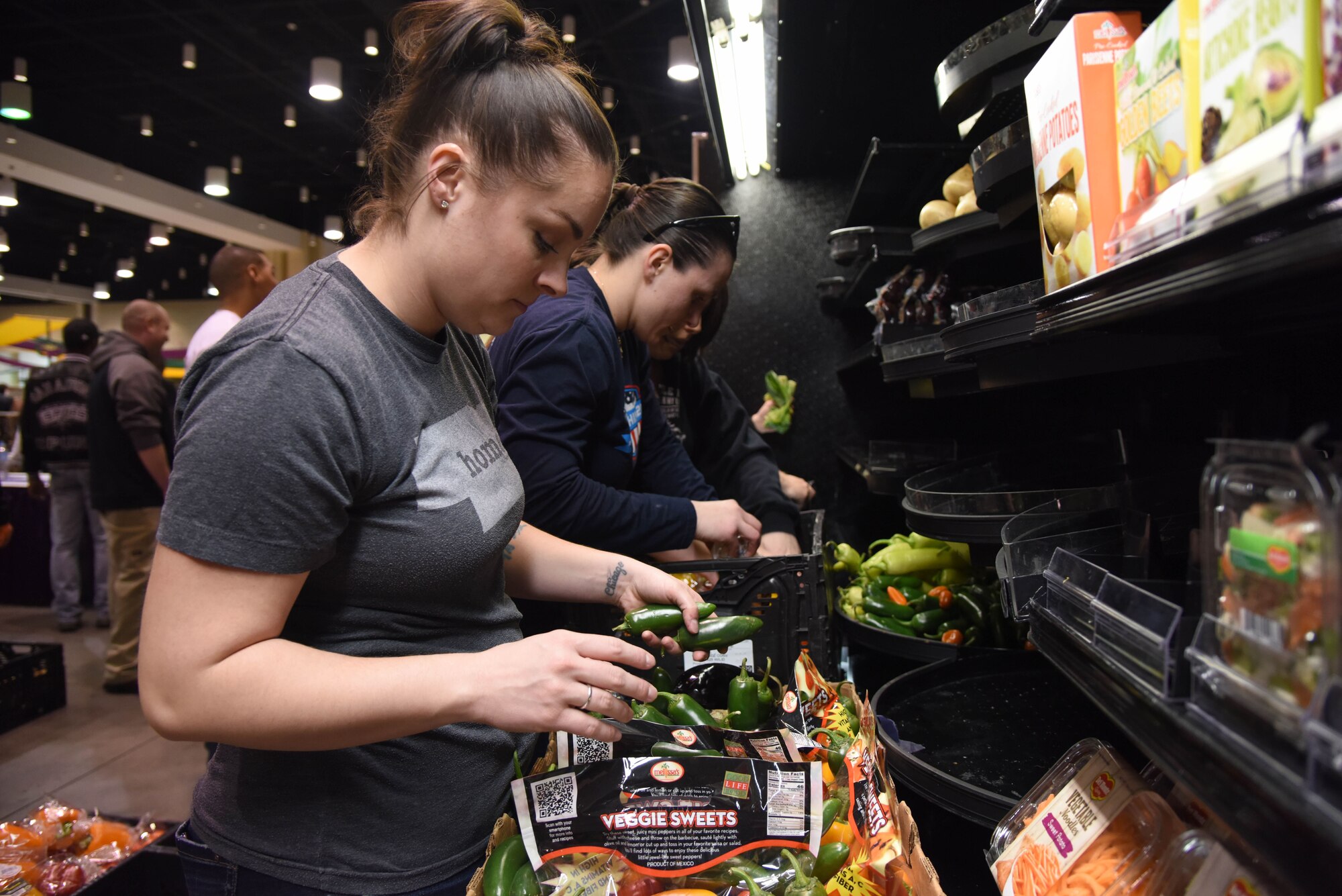 Tech. Sgt. Brittany Tyo, Mathies NCO Academy student, packages food items during a food drive at the Mississippi Coast Coliseum and Convention Center Jan. 16, 2018, Biloxi, Mississippi. More than 80 Airmen participated in the wing-level community sponsored volunteer event packaging over 21,000 pounds of food, equating to approximately 17,500 meals that will be provided to hunger relief. (U.S. Air Force photo by Kemberly Groue)