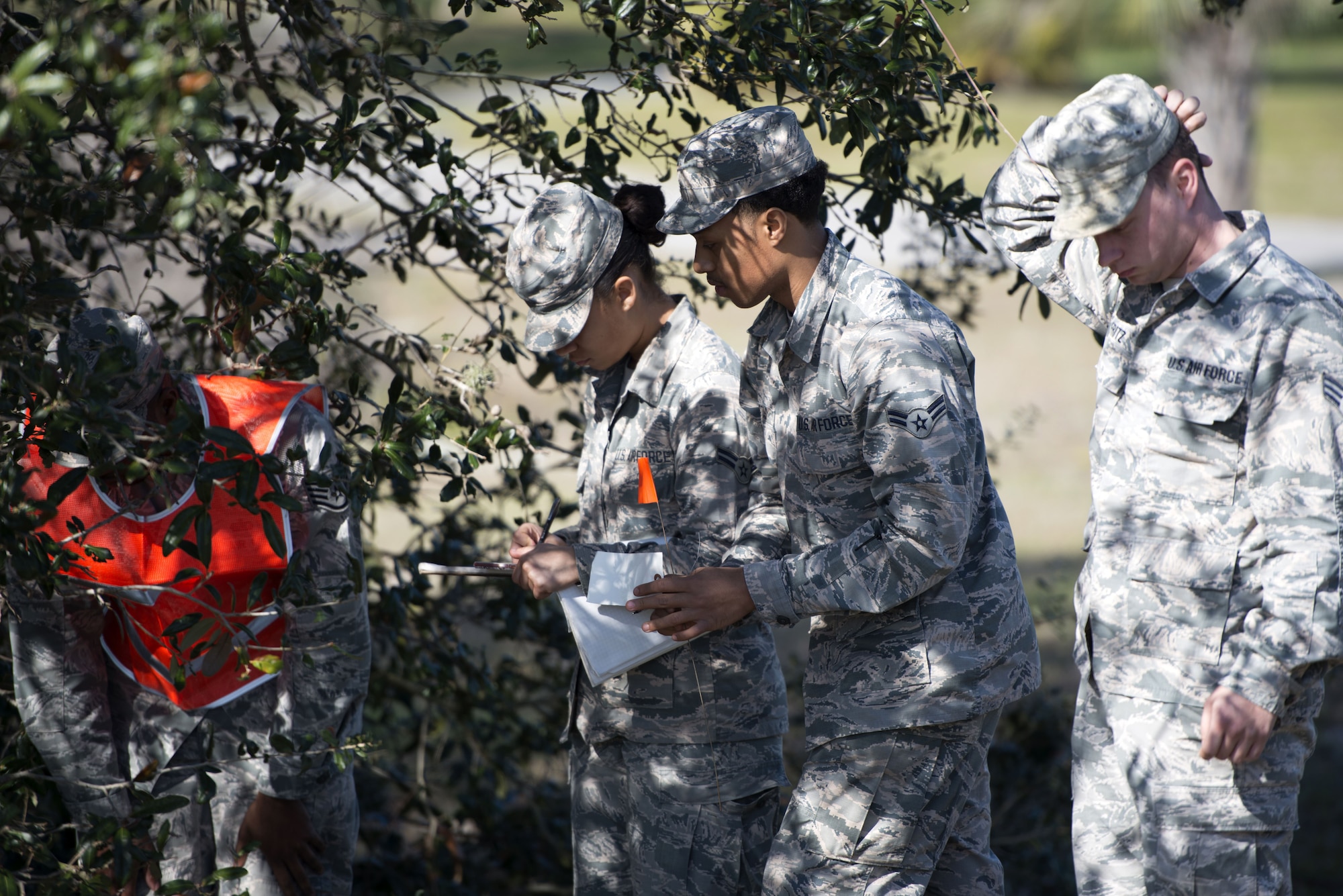 U.S. Air Force Airmen assigned to the 6th Force Support Squadron mark an object found after a simulated aircraft crash during a search and recovery training exercise Jan. 17, 2018, at MacDill Air Force Base, Fla.