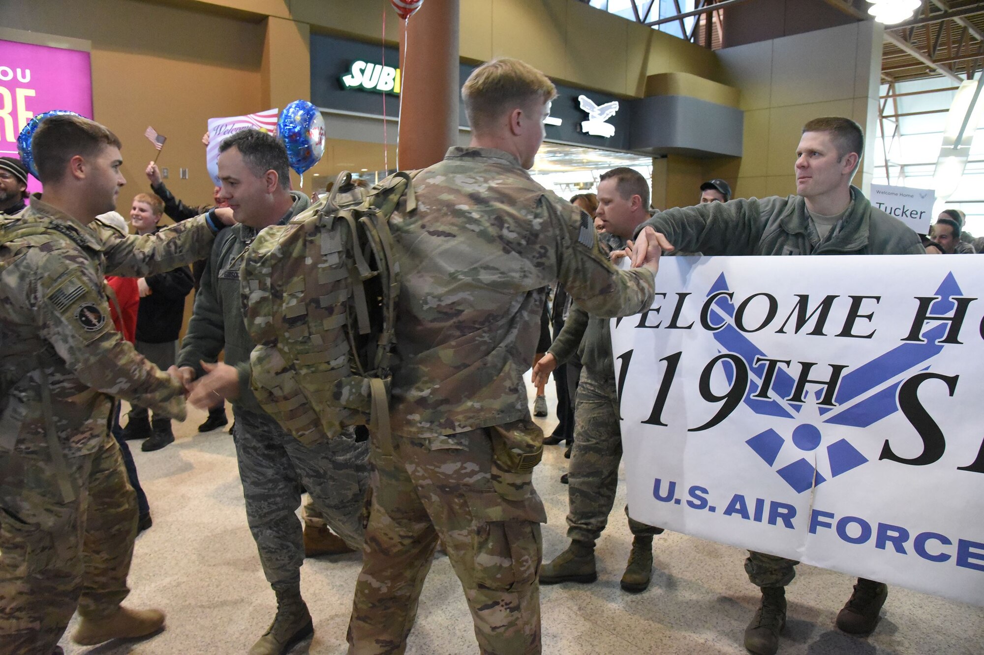 1st Lt. Jason Augdahl, the 119th Security Forces Squadron commander, and Chief Master Sgt. Steve Gibson welcome their people home from deployment.