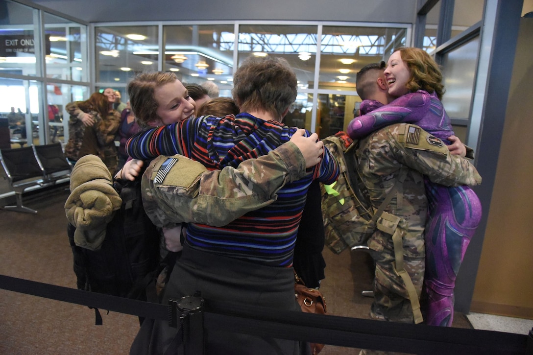Senior Airman Pamela Fehr, left, and Staff Sgt. Michael Blake, both of the 119th Security Forces Squadron, North Dakota Air National Guard, return from deployment.