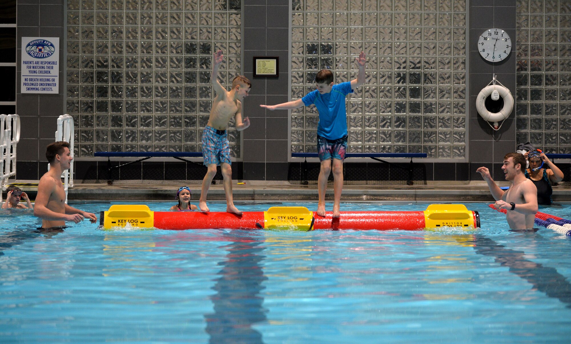 Luke Iverson and his brother Lane, sons of Master Sgt. Mike Iverson, 55th Security Forces Squadron flight chief, compete with one another to be the last sibling standing on the Key Log at the base lap-pool located in the Offutt Field House on Jan. 13, 2018.