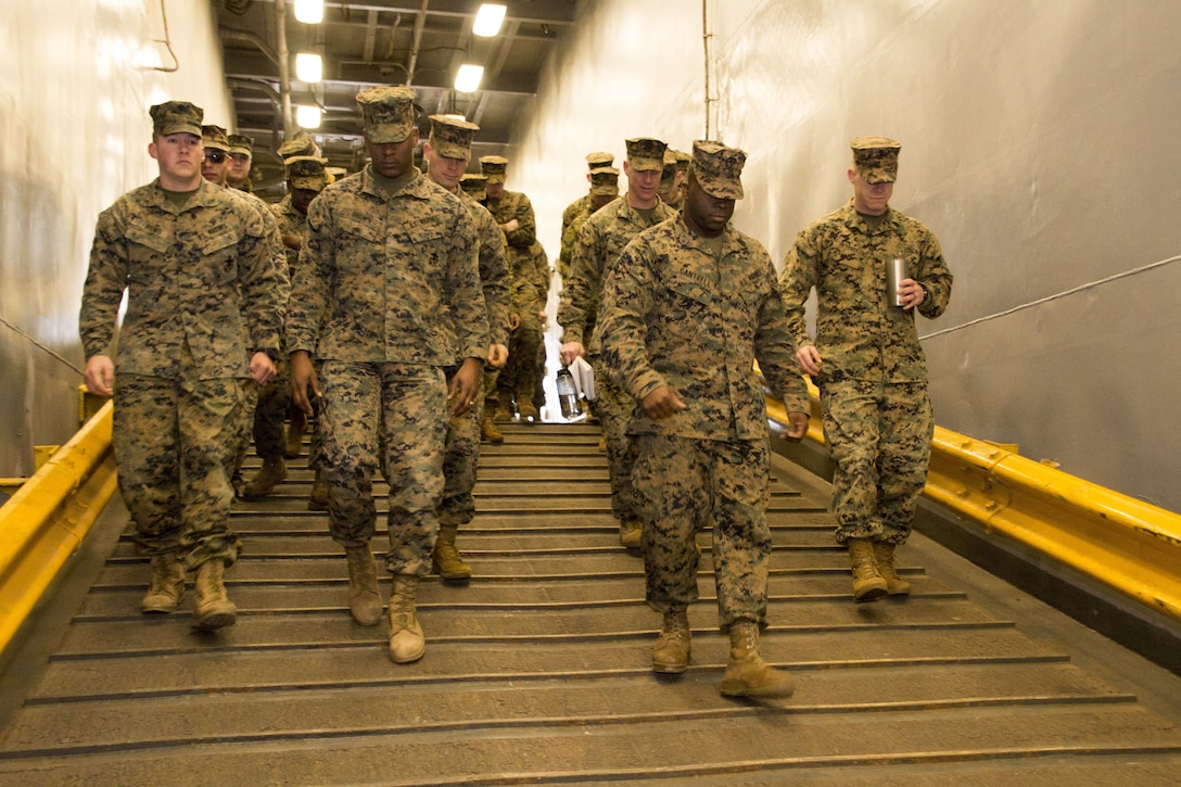 Marines from U.S. Marine Corps Forces Command walk down a ramp during a tour of the USS Carter Hall (LSD 50) led by Chief Warrant Officer 3 Christopher Freitag, chief combat cargo operator, LSD 50, aboard Joint Expeditionary Base Little
Creek, Virginia Beach, Va., Jan. 19. The Marines took part in a guided tour of the amphibious ship, gaining insight on cargo logistics. (Official U.S. Marine Corps Photo by Sgt. Mark Tuggle/Released)