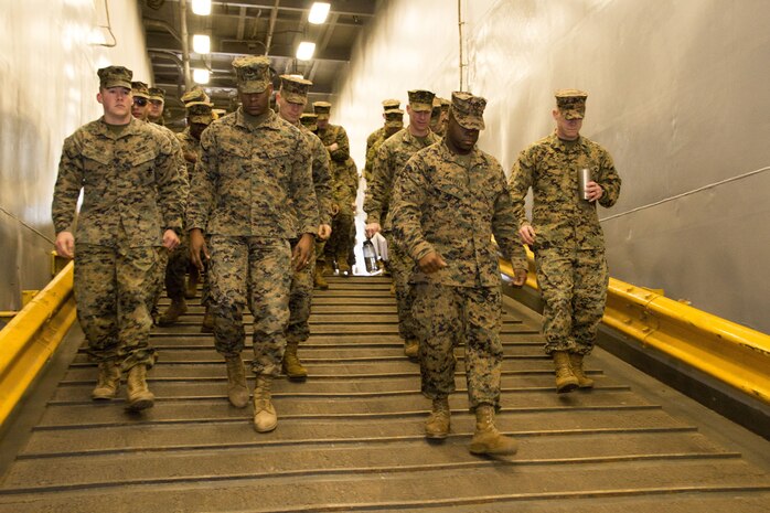 Marines from U.S. Marine Corps Forces Command walk down a ramp during a tour of the USS Carter Hall (LSD 50) led by Chief Warrant Officer 3 Christopher Freitag, chief combat cargo operator, LSD 50, aboard Joint Expeditionary Base Little Creek, Virginia Beach, Va., Jan. 19. The Marines took part in a guided tour of the amphibious ship, gaining insight on cargo logistics. (Official U.S. Marine Corps Photo by Sgt. Mark Tuggle/Released)