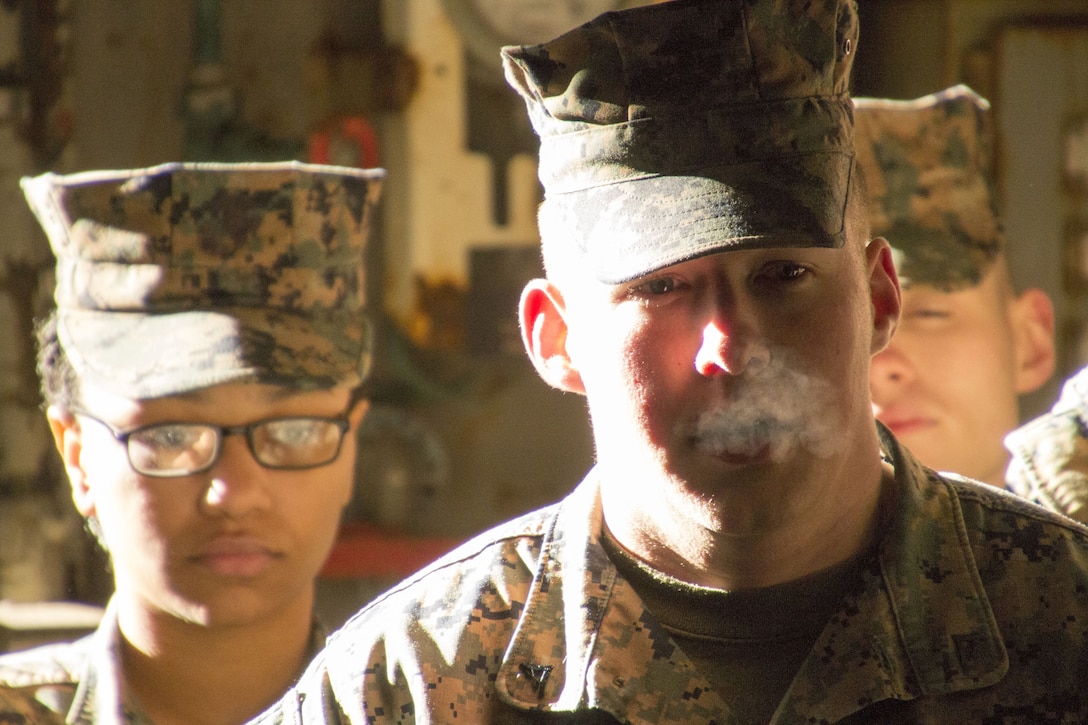 Lance Cpl. Jessie Rung, physical security specialist, Security Office, U.S. Marine Corps Forces Command, listens to Chief Warrant Officer 3 Christopher Freitag, chief combat cargo operator, LSD 50, instruct the Marines of MARFORCOM on the importance of recognizing cargo holding capabilities and constraints in holding areas  aboard USS Carter Hall (LSD 50) at Joint Expeditionary Base Little Creek, Virginia Beach, Va., Jan. 19. Marines took the tour to learn how the U.S. Navy and Marine Corps work together to accomplish a joint operation as well as gain insight on loading and unloading procedures. (Official U.S. Marine Corps Photo by Sgt. Mark Tuggle/Released)