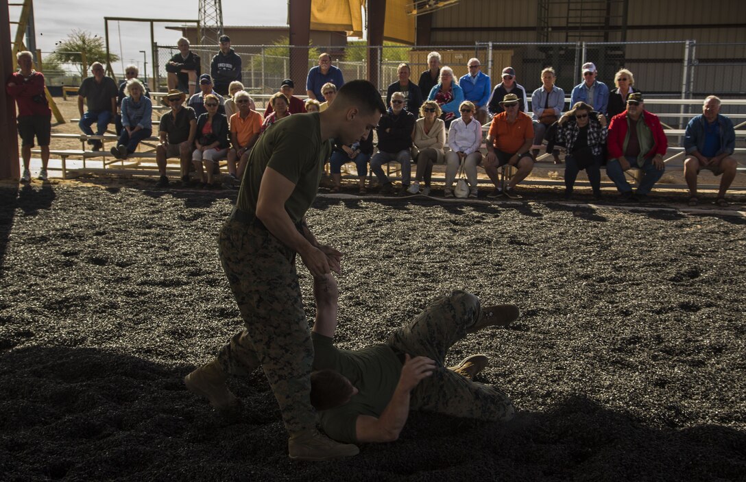 Guests participating in the first Marine Corps Air Station (MCAS) Yuma Winter Tour of the year observe the capabilities of the station, a demonstration of the K-9 unit, and an obstacle course demonstration at various locations on MCAS Yuma, Ariz., Jan. 16, 2017.  The tours have not been conducted for the past two years, but have been resumed by Col. David A. Suggs, the station commanding officer, to build a better relationship with the community. (U.S. Marine Corps photo taken by Cpl. Isaac Martinez)