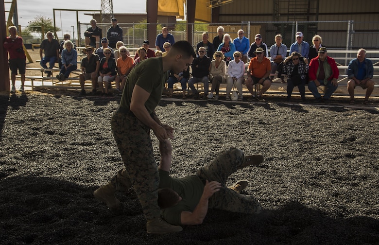 Guests participating in the first Marine Corps Air Station (MCAS) Yuma Winter Tour of the year observe the capabilities of the station, a demonstration of the K-9 unit, and an obstacle course demonstration at various locations on MCAS Yuma, Ariz., Jan. 16, 2017.  The tours have not been conducted for the past two years, but have been resumed by Col. David A. Suggs, the station commanding officer, to build a better relationship with the community. (U.S. Marine Corps photo taken by Cpl. Isaac Martinez)