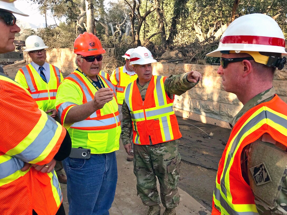 Tom Fayram, deputy public works director for Santa Barbara County, briefs Lt. Gen. Todd Semonite (center), commanding general of the U.S. Army Corps of Engineers, at the Montecito debris basin in Montecito, California, Jan. 18 during a visit to the site of a deadly mudslide. The Corps, as assigned by the Federal Emergency Management Agency, is removing more than 450,000 cubic yards of debris from 11 basins and 10 channels in areas of Santa Barbara, California, hit hard by the disaster that left 18 people dead.