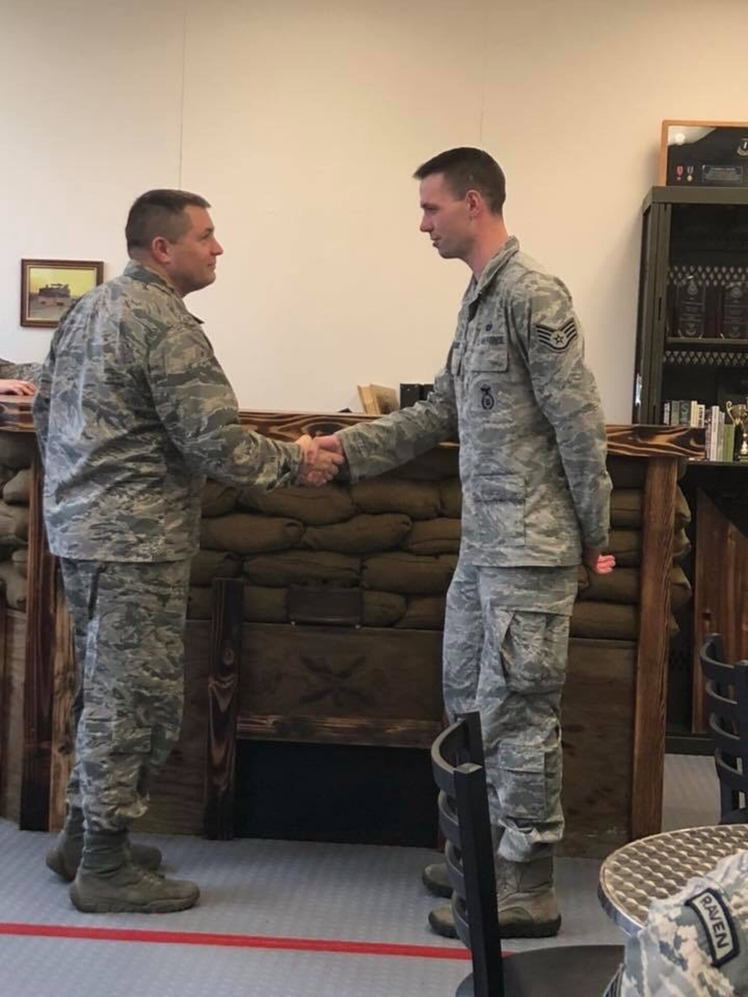 Maj. Michael Holt, 627th Security Forces Squadron commander, presents a coin to Staff Sgt. Daniel Watkins, 627th SFS unit training manager, for outstanding Airmanship, Jan. 12, 2018 at Joint Base Lewis-McChord, Wash. Watkins went above and beyond the call of duty to assist a retired Marine Corps lieutenant colonel, escorting him to an out-of-state Veterans Affairs appointment, and ensuring the gentleman’s continued care. (Courtesy photo)