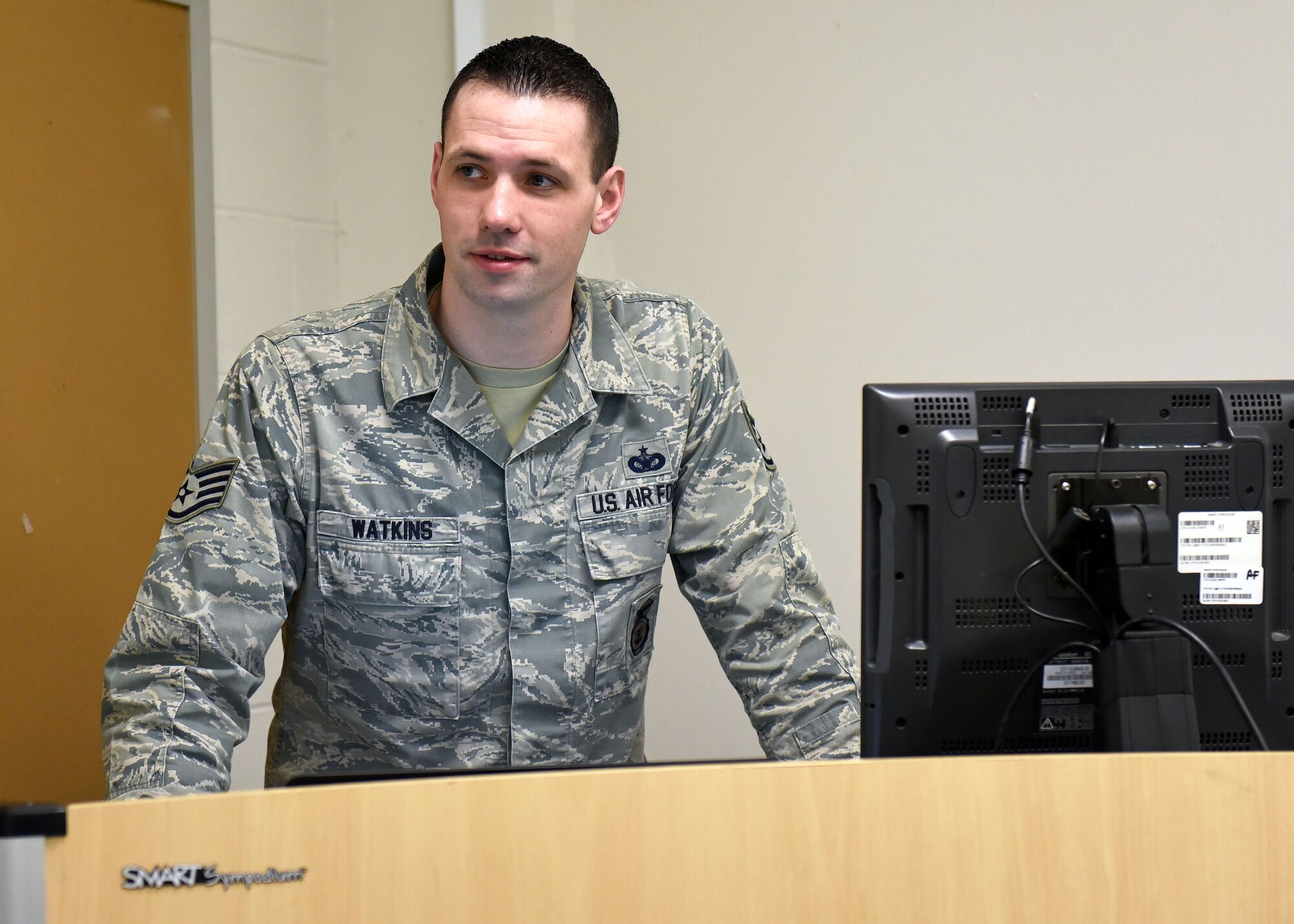 Staff Sgt. Daniel Watkins, 627th Security Forces Squadron unit training manager, stands at a podium while teaching an Expeditionary Active Shooter class at the 627th SFS, Jan. 18, 2018 at Joint Base Lewis-McChord, Wash. Watkins was recognized for outstanding Airmanship after escorting an ill, elderly veteran to an out-of-state Veterans Affairs appointment of his own volition, and ensuring the gentleman’s continued care. (U.S. Air Force photo by Staff Sgt. Whitney Taylor)