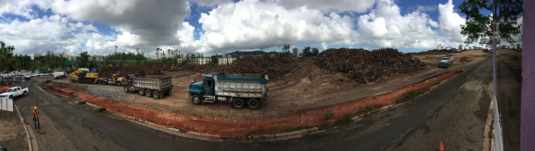 Keith Hyde, a U.S. Army Corps of Engineers natural resources specialist from the Walla Walla District’s Lucky Peak Dam and Lake in Boise, Idaho, snaps a photo Nov. 24, 2017, of contractor-operated dump trucks delivering loads of woody debris to temporary collection sites in Puerto Rico. Hyde deployed Nov. 14, 2017, volunteered to extend his initial tour of duty,to support FEMA’s debris mission. Temporary sites serve as municipal collection points for woody debris before it’s reduced to mulch or transferred to another location for permanent deposition (mulch recycling site or landfill).