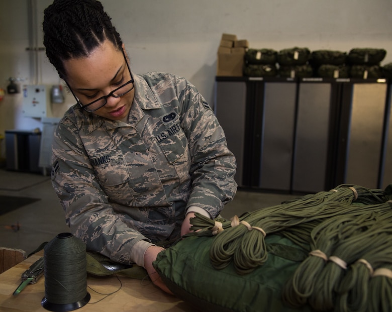 U.S. Air Force Airman 1st Class Ivory Franks, 773d Logistics Readiness Squadron combat mobility technician, packs a 26-foot high-velocity parachute at Joint Base Elmendorf-Richardson, Alaska, Jan. 18, 2018. The 26-foot high-velocity parachute is designed to support cargo bundles, which typically contain barrels of water, Meals Ready to Eat or ammunition weighing between 501 and 2,200 pounds. JBER’s combat mobility flight is the largest in PACAF, providing C-130 Hercules and C-17 Globemaster III unilateral airdrop and airland training for two wings and three squadrons while at home station, as well as all of the airdrop training to Red Flag Alaska.
