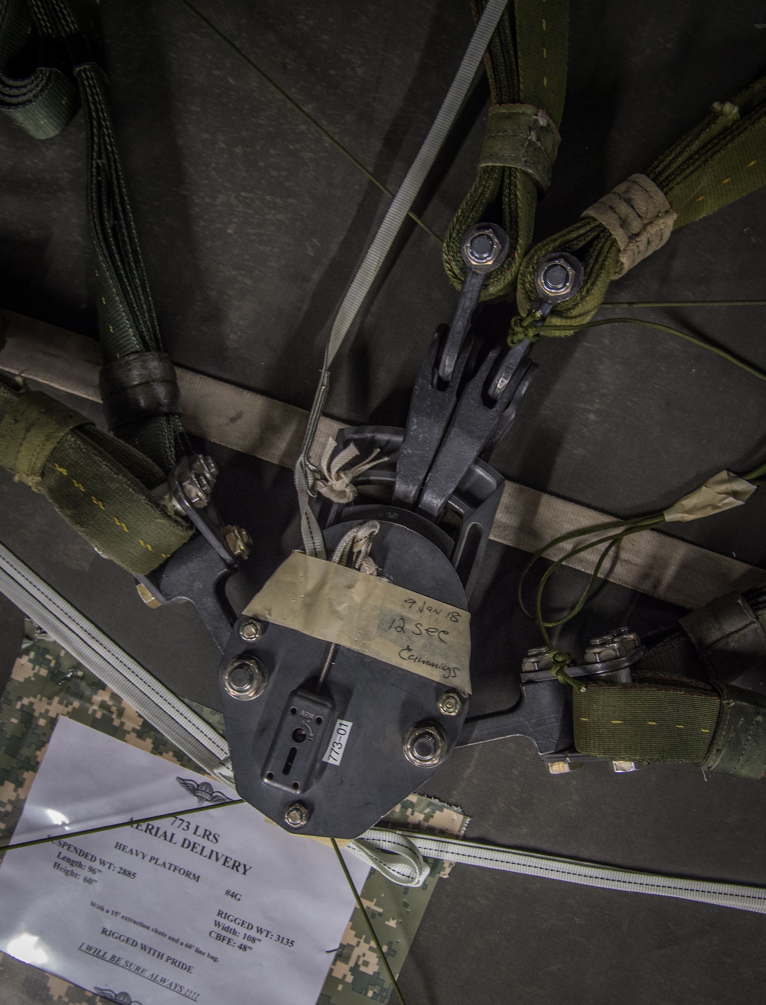 An M1 cargo parachute release rests upon a heavy cargo pallet at the 773d Logistics Readiness Squadron combat mobility flight at Joint Base Elmendorf-Richardson, Alaska, Jan. 18, 2018. As the cargo load touches down after an airdrop, the M1 triggers the parachute to fall to the side of the load, initiating the release and preventing loads from dragging or tipping. If the screws are not tightened properly, it could result in complete loss of the assets on the pallet.