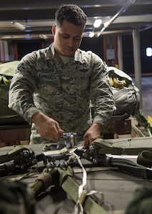 U.S. Air Force Senior Airman Roger Blumhorst, 773d Logistics Readiness Squadron combat mobility technician, tightens the screws on an M1 cargo parachute release at Joint Base Elmendorf-Richardson, Alaska, Jan. 18, 2018. As the cargo load touches down after an airdrop, the M1 triggers the parachute to fall to the side of the load, initiating the release and preventing loads from dragging or tipping. If the screws are not tightened properly, it could result in complete loss of the assets on the pallet.