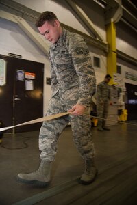 U.S. Air Force Airman 1st Class Zachary Barber, 773d Logistics Readiness Squadron combat mobility technician, takes slack out of a parachute line at Joint Base Elmendorf-Richardson, Alaska, Jan. 18, 2018. JBER’s combat mobility flight is the largest in PACAF, providing C-130 Hercules and C-17 Globemaster III unilateral airdrop and airland training for two wings and three squadrons while at home station, as well as all of the airdrop training to Red Flag Alaska.