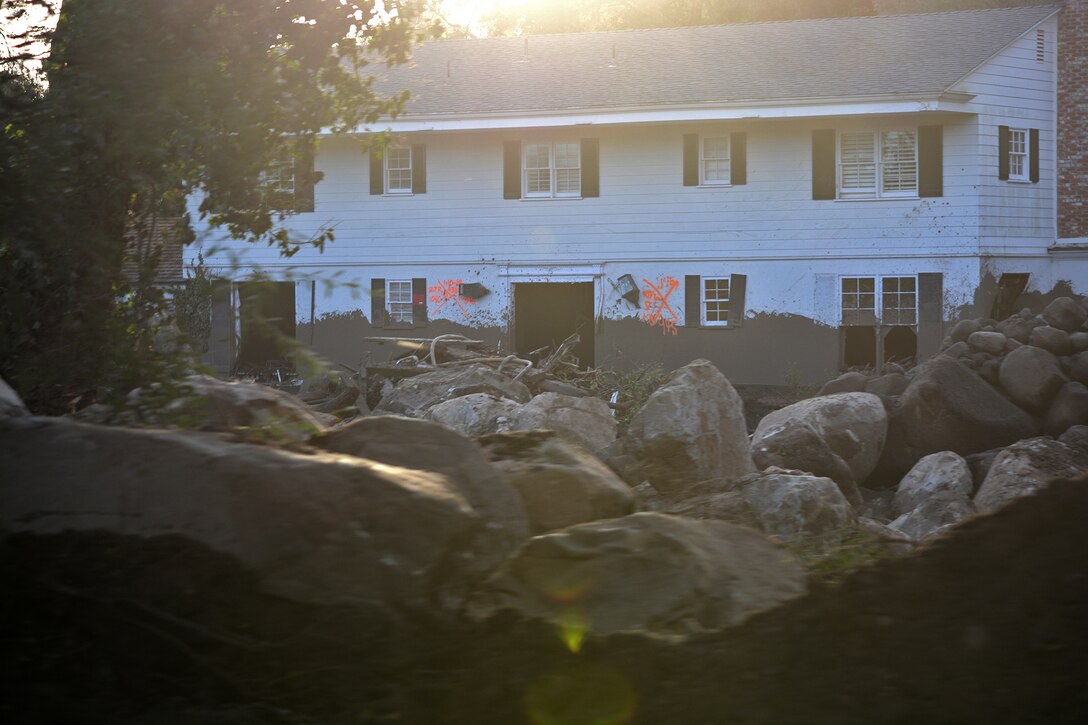 Large boulders litter the front yard of a home in Montecito, California, Jan. 18. The Corps, as assigned by the Federal Emergency Management Agency, is removing more than 450,000 cubic yards of debris from 11 basins and 10 channels in areas of Santa Barbara, California, hit hard by the disaster that left 18 people dead.