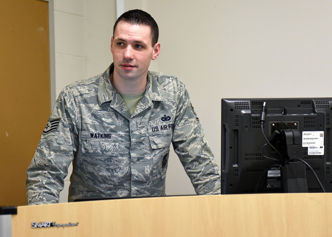 Staff Sgt. Daniel Watkins, 627th Security Forces Squadron unit training manager, stands at a podium while teaching an Expeditionary Active Shooter class at the 627th SFS, Jan. 18, 2018 at Joint Base Lewis-McChord, Wash. Watkins was recognized for outstanding Airmanship after escorting an ill, elderly veteran to an out-of-state Veterans Affairs appointment of his own volition, and ensuring the gentleman’s continued care. (U.S. Air Force photo by Staff Sgt. Whitney Taylor)