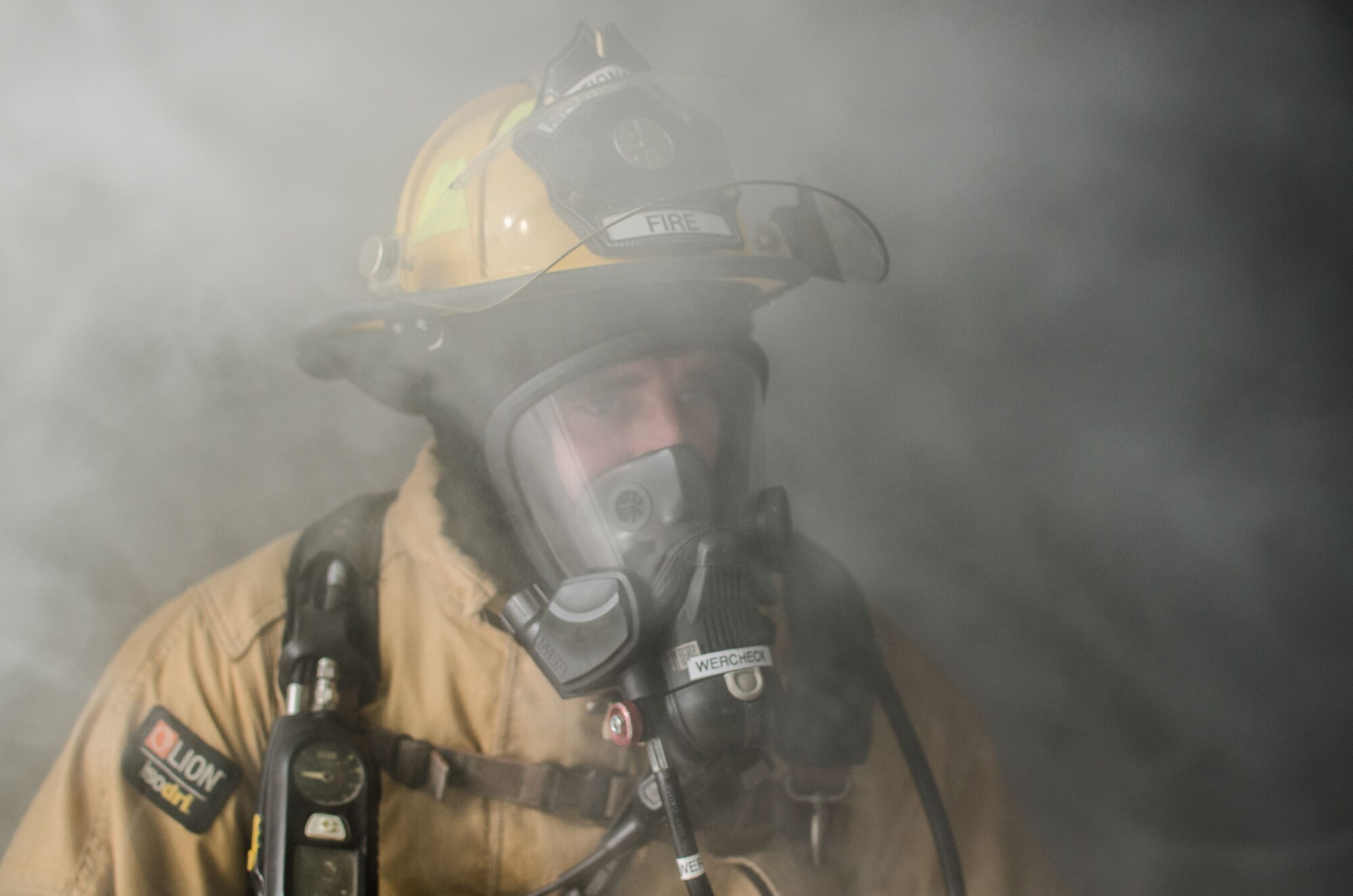 U.S. Air Force Senior Airman Steven Werchek, 380th Expeditionary Civil Engineer Squadron firefighter, observes as his wingman extinguishes a simulated fire at Al Dhafra Air Base, United Arab Emirates, Jan. 12, 2018. The firefighters utilized the “two-in, two-out” policy that mandates that firefighters never enter a building alone during a rescue mission. (U.S. Air National Guard photo by Staff Sgt. Colton Elliott)