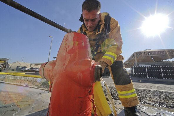 U.S. Air Force Senior Airman Steven Werchek, 380th Expeditionary Civil Engineer Squadron firefighter, removes a hose from a fire hydrant after a simulated burning building at Al Dhafra Air Base, United Arab Emirates, Jan. 12, 2018. The scenario involved an electrical fire in which one survivor wasn’t accounted for. (U.S. Air Force photo by Airman 1st Class D. Blake Browning)