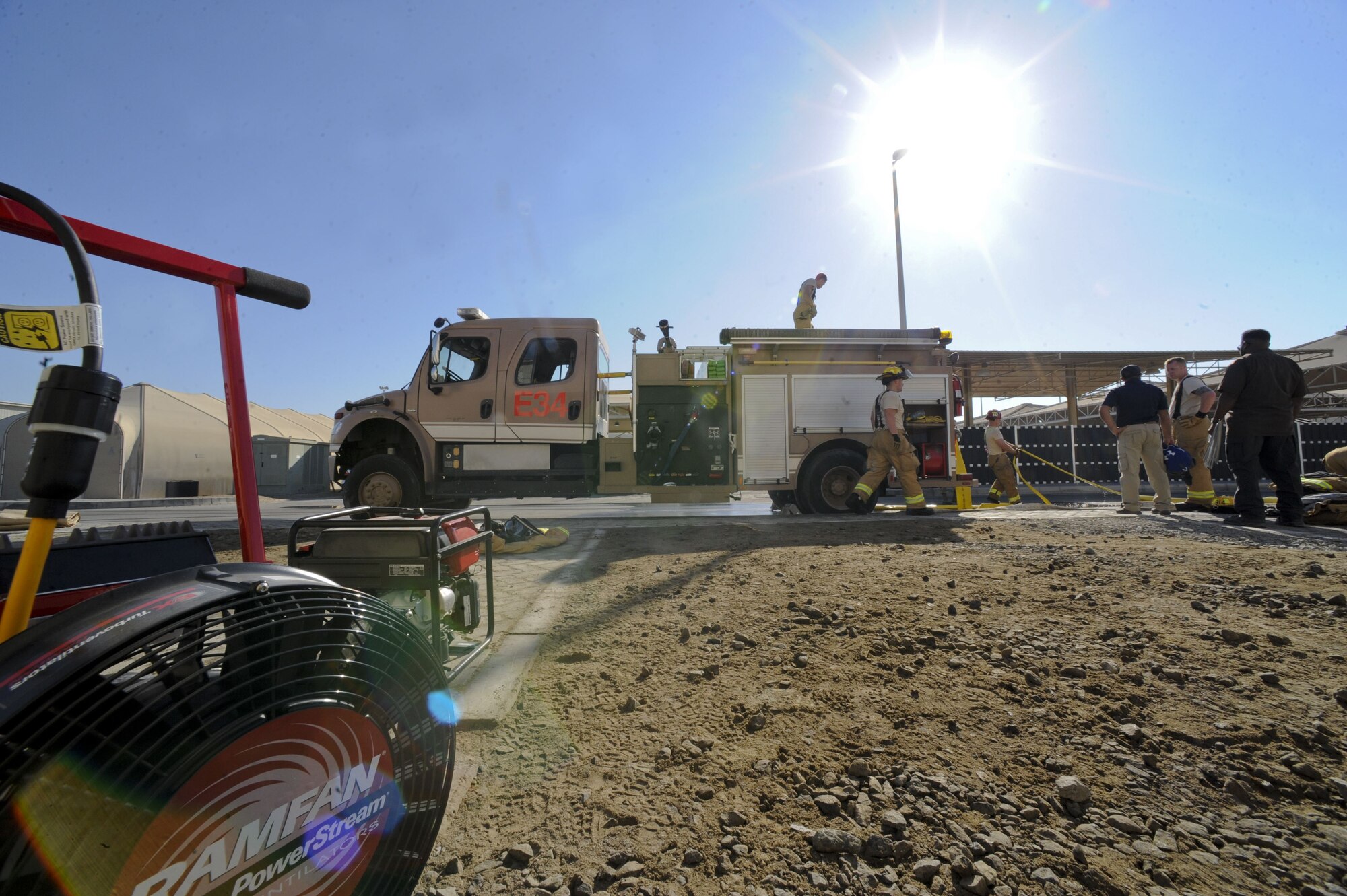 Airmen assigned to the 380th Expeditionary Civil Engineer Squadron clean up after a simulated building fire at Al Dhafra Air Base, United Arab Emirates, Jan. 12, 2018. Firefighters occasionally perform practical based training to ensure their skills stay relevant. (U.S. Air Force photo by Airman 1st Class D. Blake Browning)
