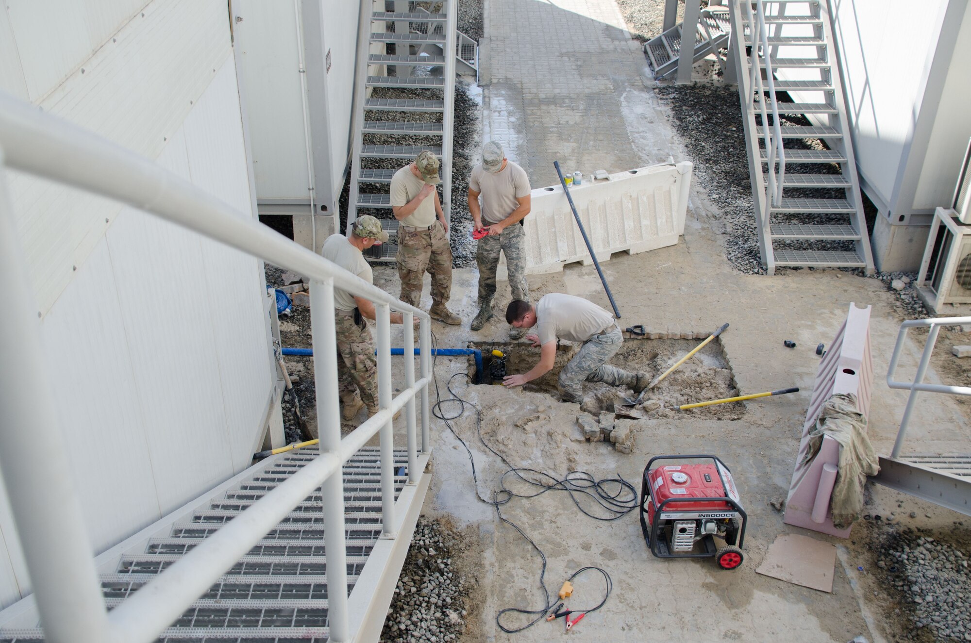 Airmen from the 380th Expeditionary Civil Engineering Squadron, water and fuels systems maintenance repairs a damaged water pipe at Al Dhafra Air Base, United Arab Emirates Jan. 11, 2018.  The ECES team repaired the pipe and restored water supply to deployed personnel. (U.S. Air National Guard photo by Staff Sgt. Colton Elliott)