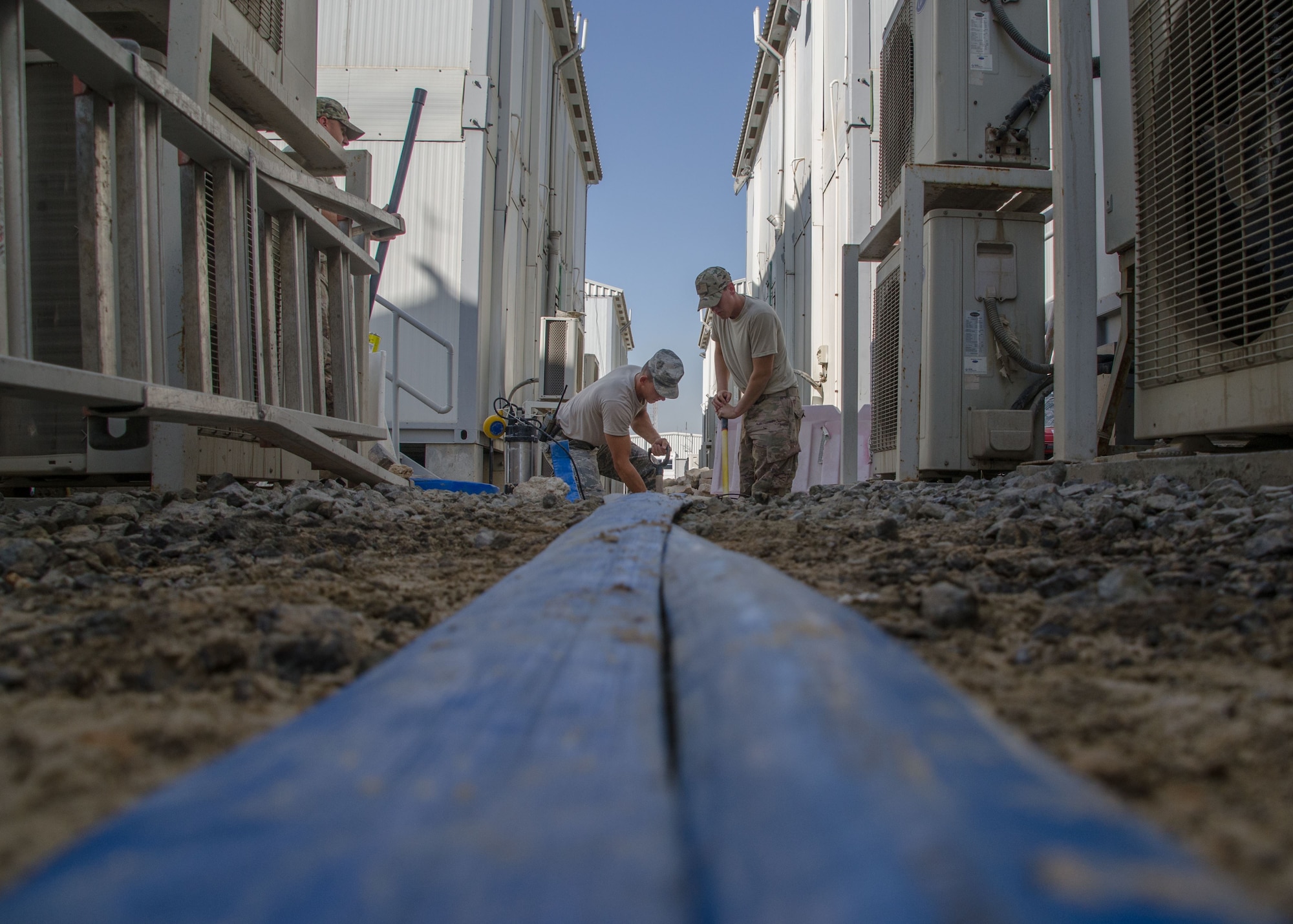 Airmen from the 380th Expeditionary Civil Engineering Squadron, water and fuels maintenance restore a damaged water pipe at Al Dhafra Air Base, United Arab Emirates Jan. 11, 2018.  Water and fuels manage the plumbing, wastewater collection system, liquid fuel storage and natural gas distribution systems on every base. (U.S. Air National Guard photo by Staff Sgt. Colton Elliott)