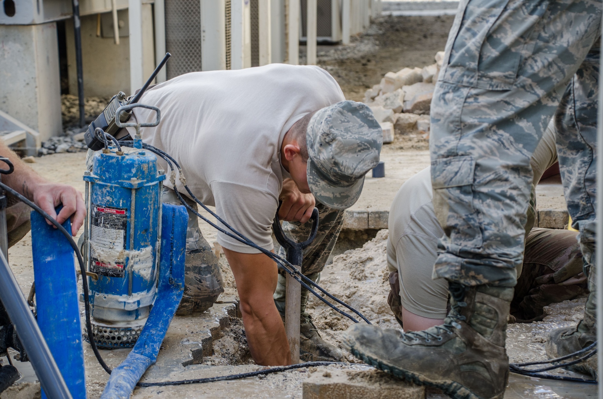 Senior Airman Malachi Nemitz, 380th Expeditionary Civil Engineering Squadron, water and fuels system specialist, shovels out dirt to find a damaged water line at Al Dhafra Air Base, United Arab Emirates Jan. 11, 2017. (U.S. Air National Guard photo by Staff Sgt. Colton Elliott)