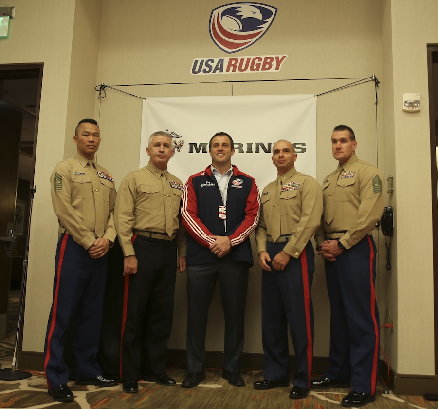 Sgt. Maj. Mike Lanpolsaen (left), Maj. Gen. Paul Kennedy, Dan Payne, Maj. Benjamin Heredia and Sgt. Maj. Jon Jerome pose for a photo  during the USA Rugby 2018 National Development Summit in Denver, Colorado, January 19, 2018. During the summit, Kennedy announced a new partnership between the Marine Corps and USA Rugby. The Marine Corps partners with organizations that share its core values of honor, courage, and commitment. Rugby, which is well-known for instilling discipline, physical fitness, and mental toughness on its players, was a natural choice for the Marines. As an official partner of USAR, Marines will have the opportunities to attend several USAR events such as training and education seminars, college championships, and high school regional cup tournaments. Lanpolsaen is the sergeant major of Marine Corps Recruiting Command . Kennedy is the commanding general of Marine Corps Recruiting Command. Payne is the chief executive officer of USAR. Heredia is the commanding officer of Marine Corps Recruiting Station Denver. Jerome is the sergeant major of Recruiting Station Denver.