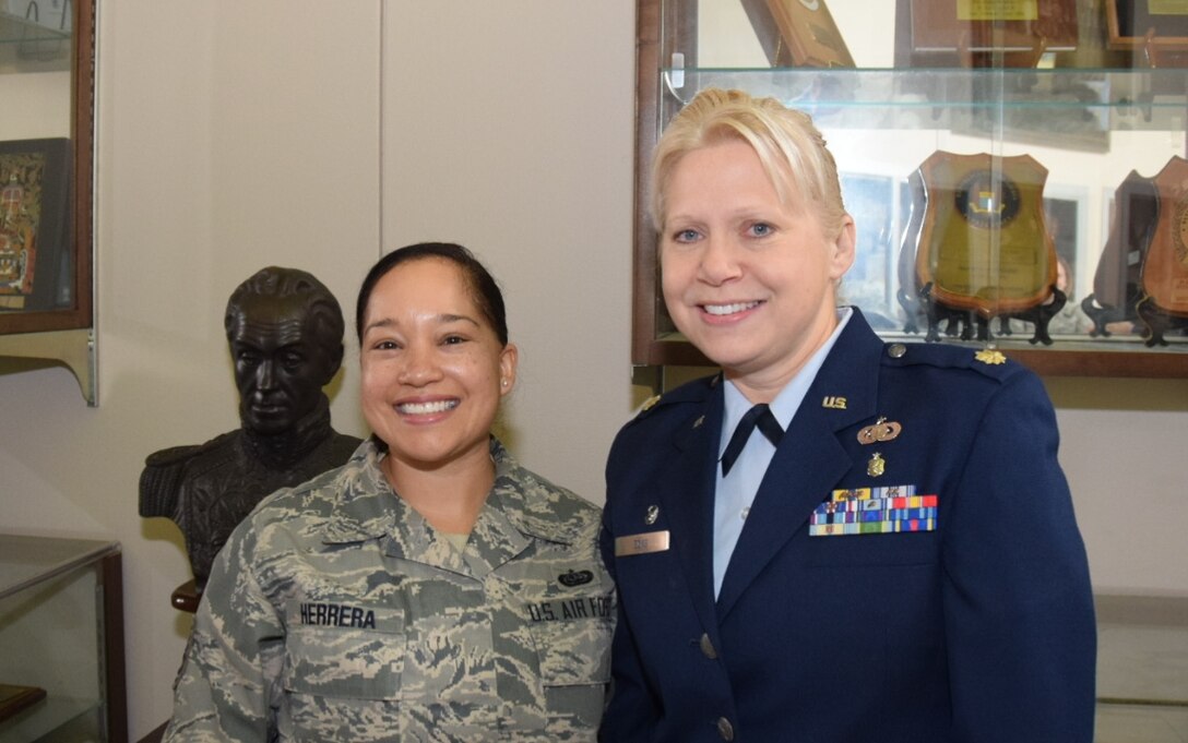 Tech. Sgt. Kim Herrera (left), 433rd Airlift Wing historian, congratulates Maj. Robin L. Ecks, the new 433rd Force Support Squadron after her assumption of command ceremony held at the Inter American Air Force Academy auditorium on Joint Base San Antonio-Lackland, Texas on Jan. 20, 2018. (U.S. Air Force photo by Tech Sgt. Carlos J. Treviño)