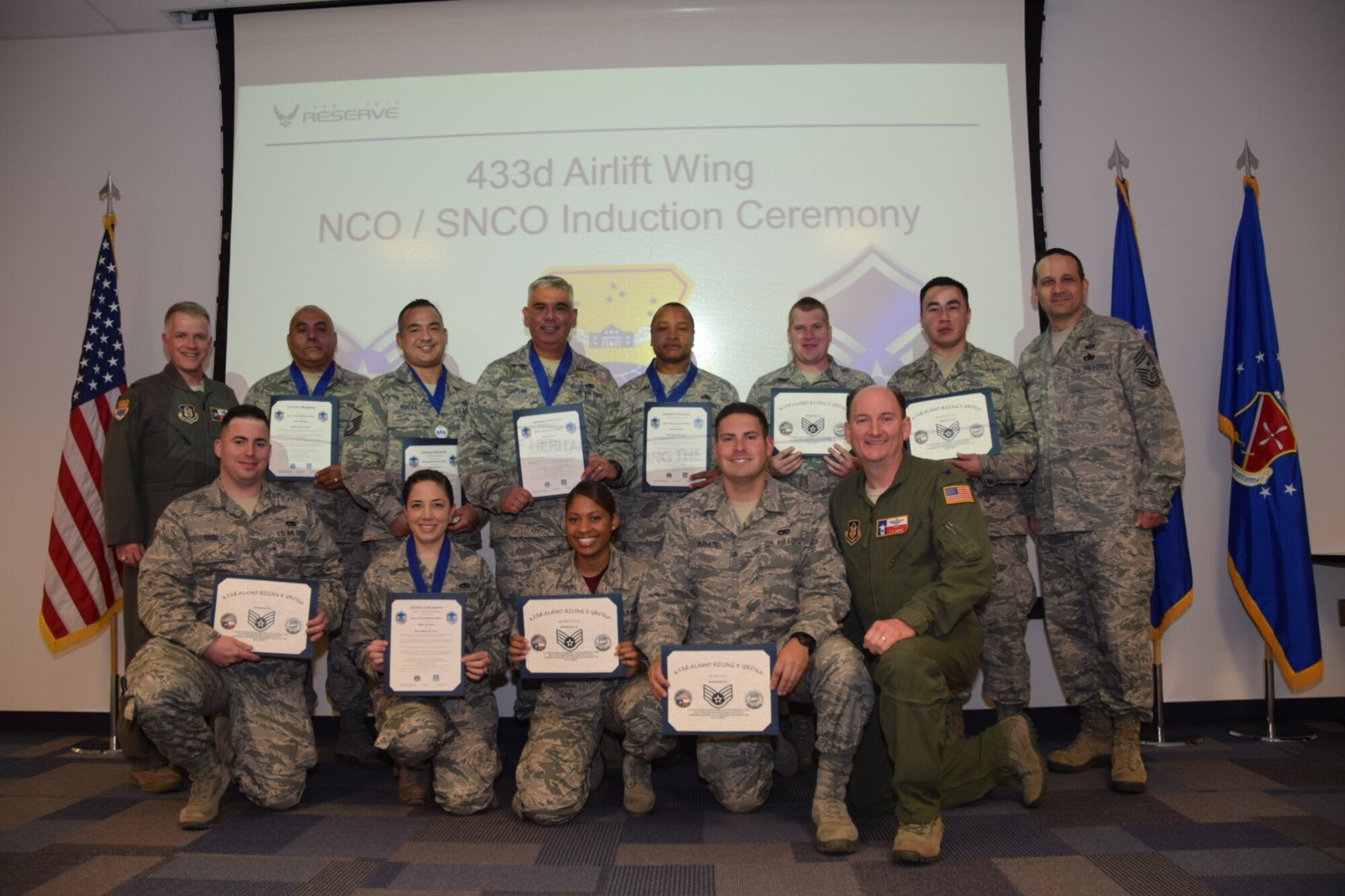 Col. Thomas K. Smith Jr.(bottom row, right), 433rd Airlift Wing commander, congratulated the 433rd Airlift Wing Senior NCO and NCO inductees during a ceremony , sponsored by The Alamo Wing Top 3 Association, Chief's Group, First Sergeants Council and Alamo Rising 6, at the Robert D. Gaylor NCO Academy here 20 Jan 2018.  Smith encouraged the newly inducted Airmen to continue professionally progressing. (U.S. Air Force photo by Tech Sgt. Carlos J. Treviño)