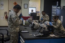 U.S. Air Force Airmen from the 44th Fighter Squadron aircrew flight equipment shop clean and inspect aircrew flight equipment Jan. 18, 2018, at Kadena Air Base, Japan. AFE Airmen maintain helmets, joint helmeted mounted cueing systems, harness', survival vests, advanced technology anti-gravity systems, gravity suits, night vision goggles and chemical gear. (U.S. Air Force photo by Staff Sgt. Micaiah Anthony)