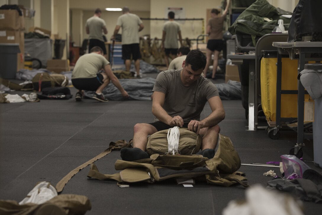 Aircrew flight equipment Airmen from the 31st Rescue Squadron and AFE augmentees from Davis Monthan Air Force Base, Ariz., assemble and pack advanced ram air parachute systems Jan. 18, 2018, at Kadena Air Base, Japan. AFE Airmen from the 31st RQS are authorized to wear an alternate uniform since sweat and certain parts of the uniform have the potential to damage the parachute or hinder Airmen from effectively packing parachutes. (U.S. Air Force photo by Staff Sgt. Micaiah Anthony)