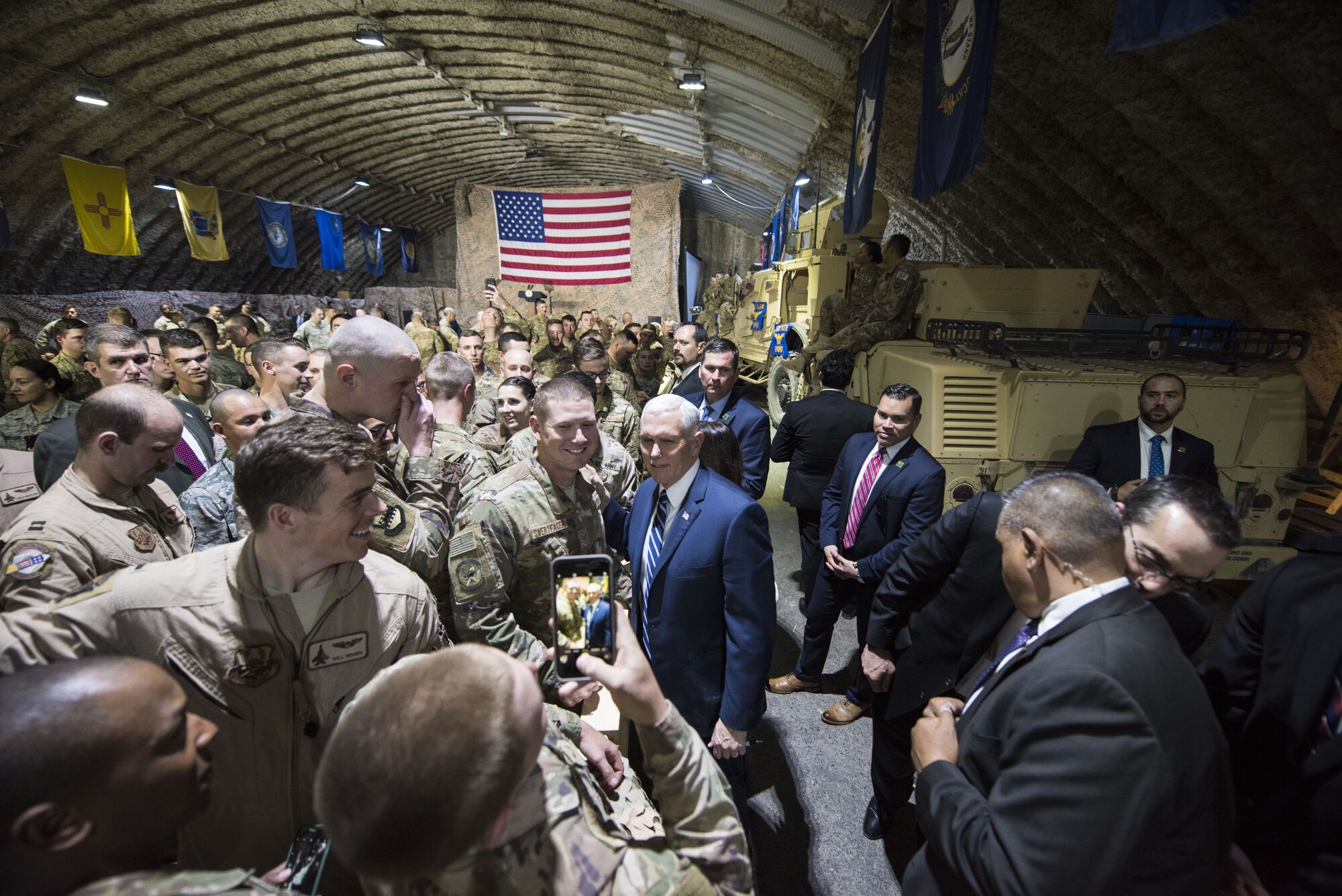 U.S. Vice President Mike Pence poses for photos with Airmen assigned to the 332d Air Expeditionary Wing, January 21, 2018 at an undisclosed location in Southwest Asia. During a speech delivered to a large crowd gathered to greet him, Pence praised service members for their continued dedication to the mission despite their own personal sacrifices. (U.S. Air Force photo by Staff Sgt. Joshua Kleinholz)