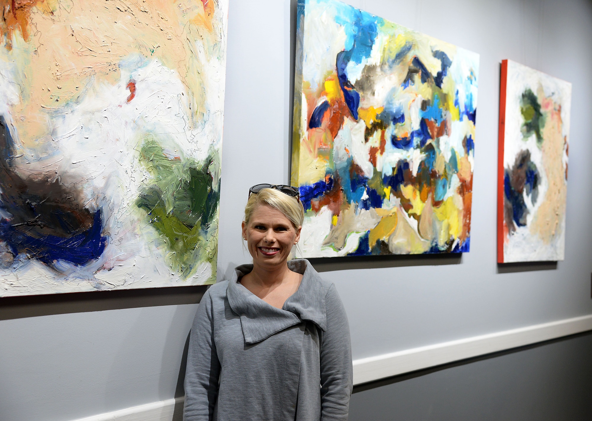 Emmie Sherertz, local artist, stands next to her work Jan. 12, 2018, inside of the Club on Columbus Air Force Base, Mississippi. The Club art gallery was created in 2015 with the opening of the newly renovated Club. The Columbus Arts Council switches the art out roughly every two months, providing six artists a year to showcase their work to the Columbus AFB service members and family. (U.S. Air Force photo by Airman 1st Class Keith Holcomb)