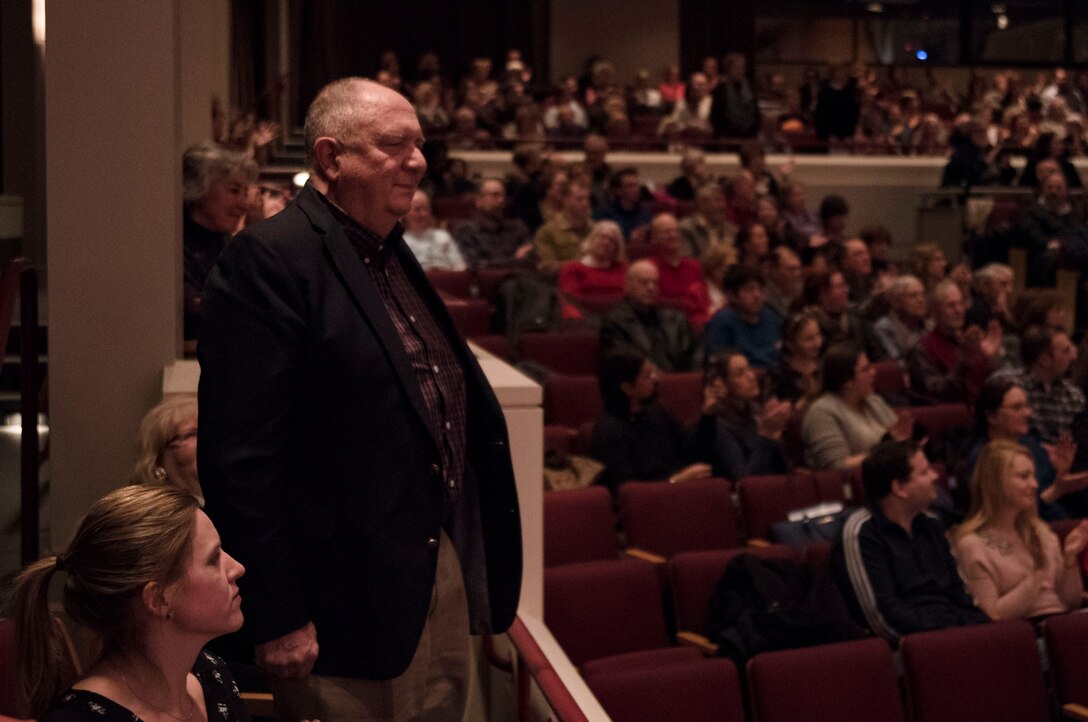 Retired Marine Sergeant stands for Marine Corps song