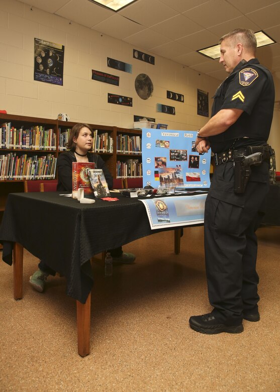 A student displays her presentation to Cpl. Chris Stevens during the Bolden Elementary and Middle School Wax Museum aboard Laurel Bay Jan. 17. Stevens is the School Resource Officer for Laurel Bay schools.