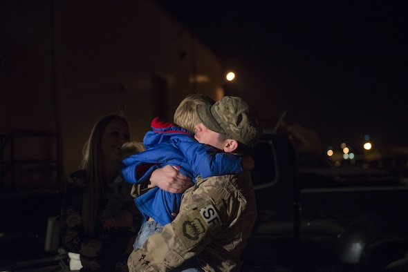 Staff Sgt. Issac McCauley, 436th Security Forces Squadron defender, hugs his son, Channing Hooser, after returning home from deployment to the Middle East Jan. 21, 2018, at Dover Air Force Base, Del. McCauley was welcomed home by his family after his six-month long deployment. (U.S. Air Force photo by Airman 1st Class Zoe M. Wockenfuss)