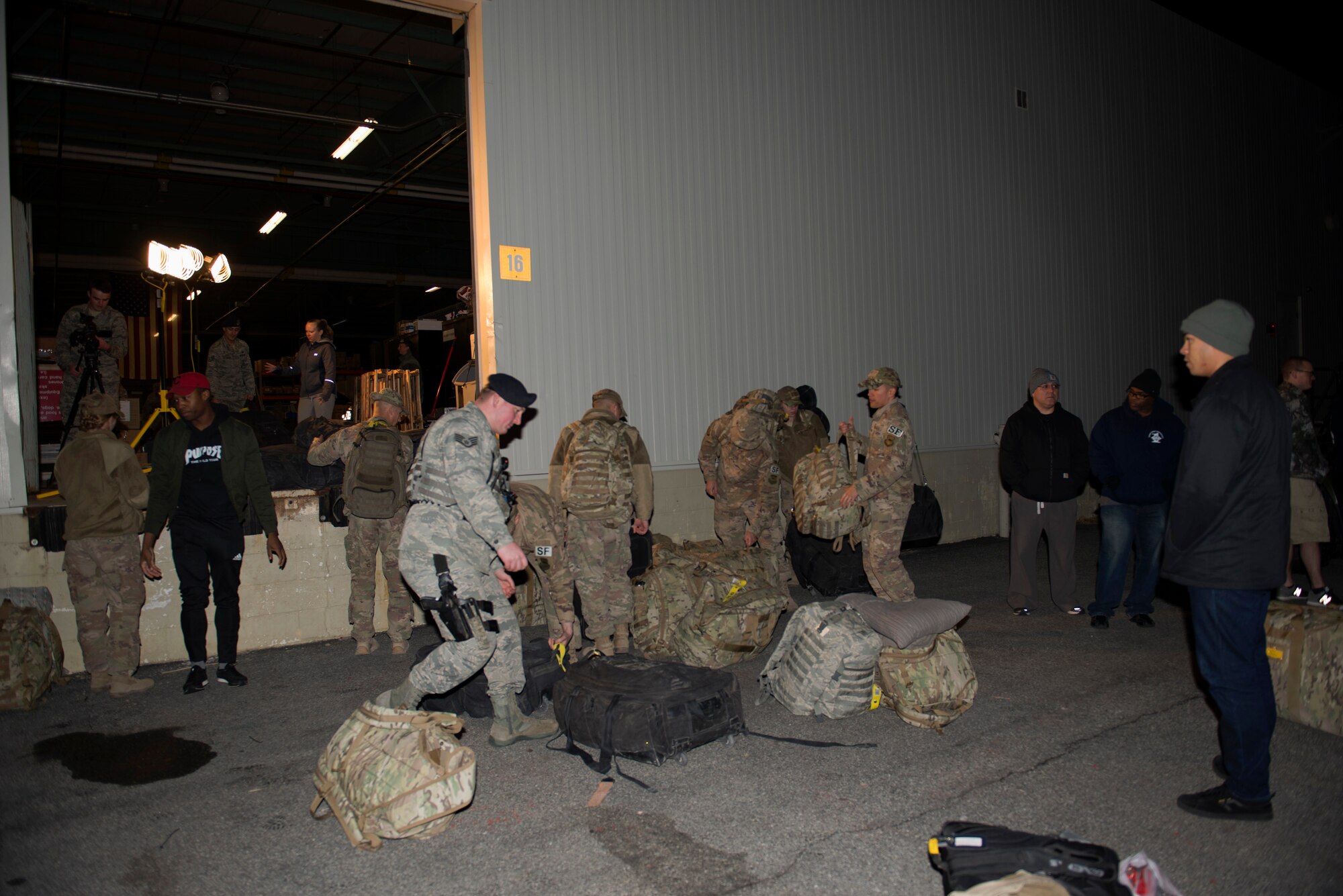 Members of the 436th Security Forces Squadron return home from deployment to the Middle East Jan. 21, 2018, at Dover Air Force Base, Del. The team dropped off their bags and went home with their families after a long flight back to the United States. (U.S. Air Force photo by Airman 1st Class Zoe M. Wockenfuss)