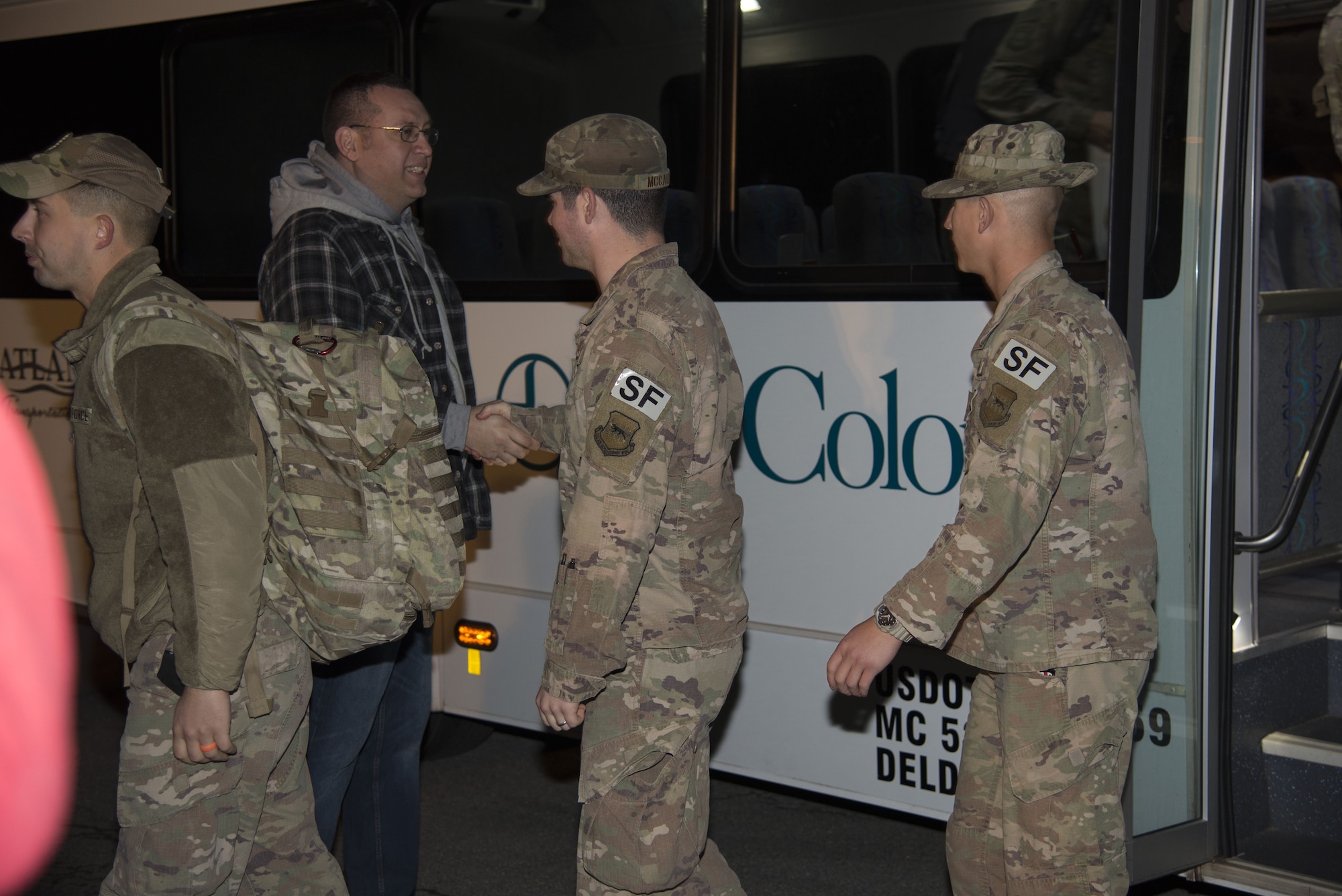 Defenders assigned to the 436th Security Forces Squadron return home from deployment to the Middle East Jan. 21, 2018, at Dover Air Force Base, Del. The 12 Defenders departed the bus after a long day of flights returning them to Dover AFB. (U.S. Air Force Photo by Staff Sgt. Aaron J. Jenne)