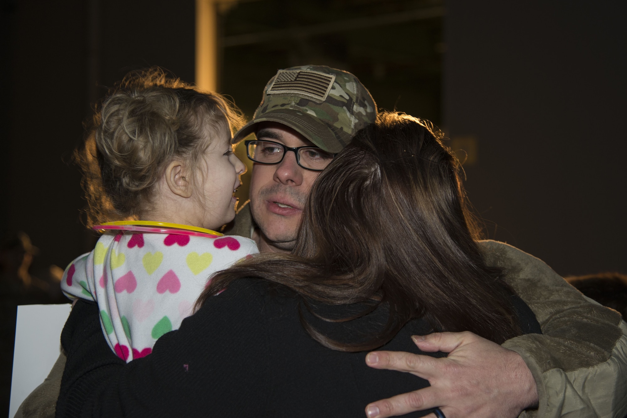 Master Sgt. Michael Johnson, 436th Security Forces Squadron defender, embraces his daughter, Amelia, and wife, Kelly, upon his return home from deployment Jan. 21, 2018, at Dover Air Force Base, Del. Johnson’s team was deployed to the Middle East for six months. (U.S. Air Force Photo by Staff Sgt. Aaron J. Jenne)