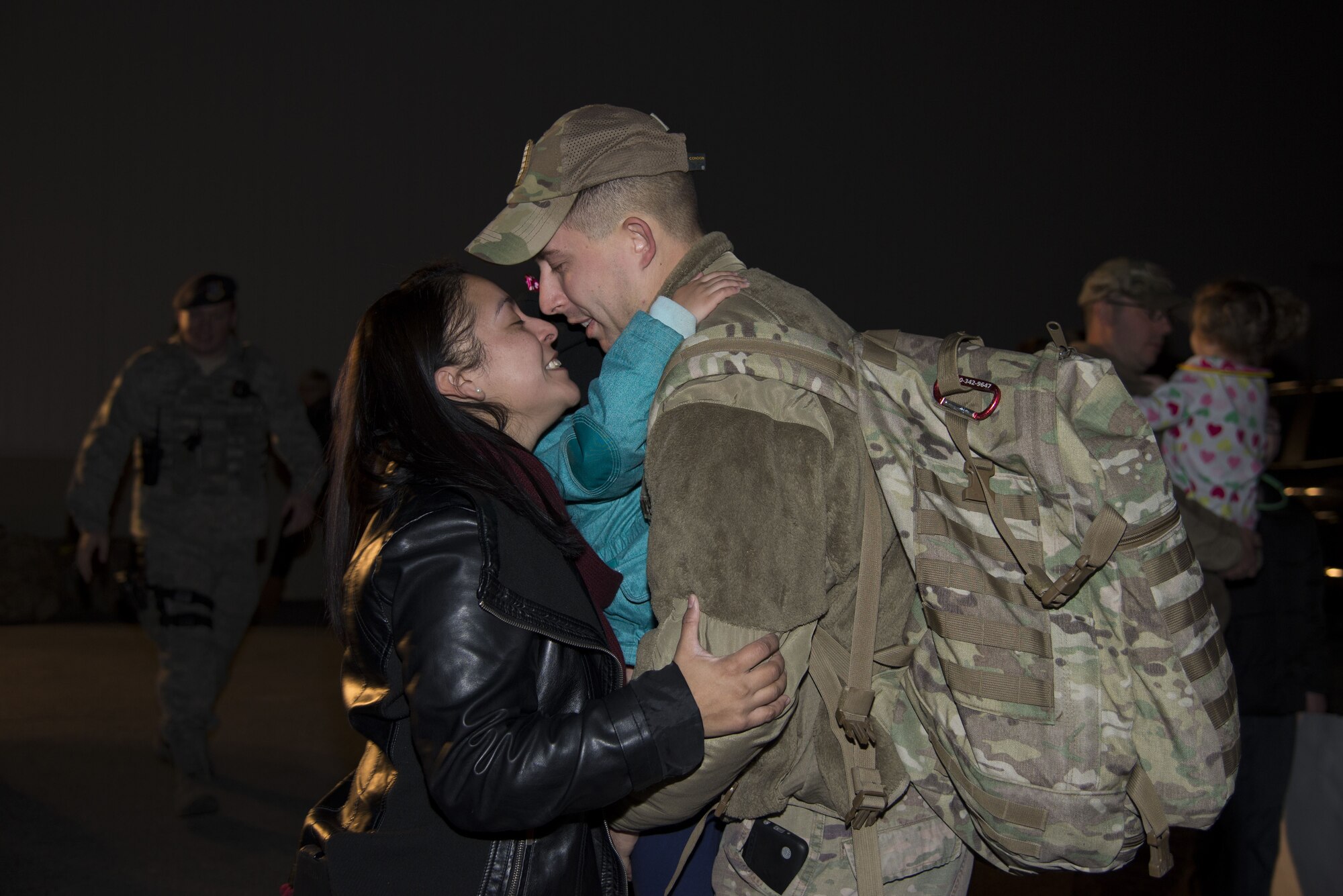 Staff Sgt. Justin Stevenson, 436th Security Forces Squadron defender, kisses his wife, Jamielee, while hugging his daughter, Julia, upon his return home from deployment to the Middle East Jan. 21, 2018, at Dover Air Force Base, Del. Stevenson’s team has been deployed since July 2017. (U.S. Air Force Photo by Staff Sgt. Aaron J. Jenne)