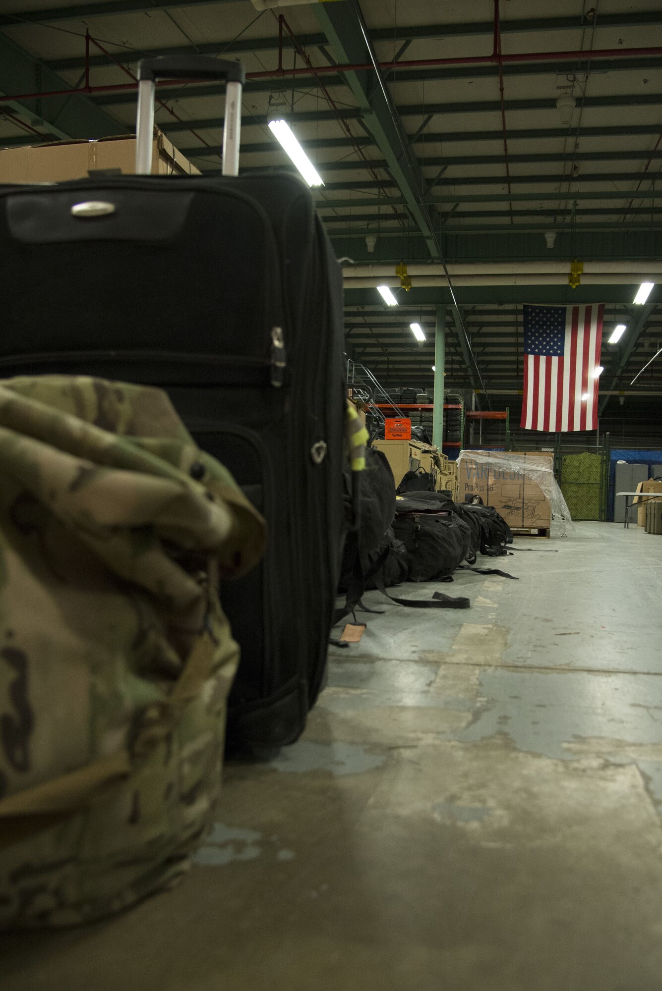 Luggage belonging to 12 returning 436th Security Forces Squadron defenders rests in a warehouse after a six-month deployment to the Middle East, Jan. 21, 2018, at Dover Air Force Base, Del. Families and unit members met the defenders upon their return. (U.S. Air Force Photo by Staff Sgt. Aaron J. Jenne)