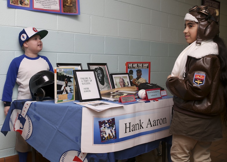 Students discuss their presentations during the Bolden Elementary and Middle School Wax Museum aboard Laurel Bay Jan. 17. Each Student chose a historical figure to impersonate and performed a short presentation. These students posed as Hank Aaron and Bessie Coleman.