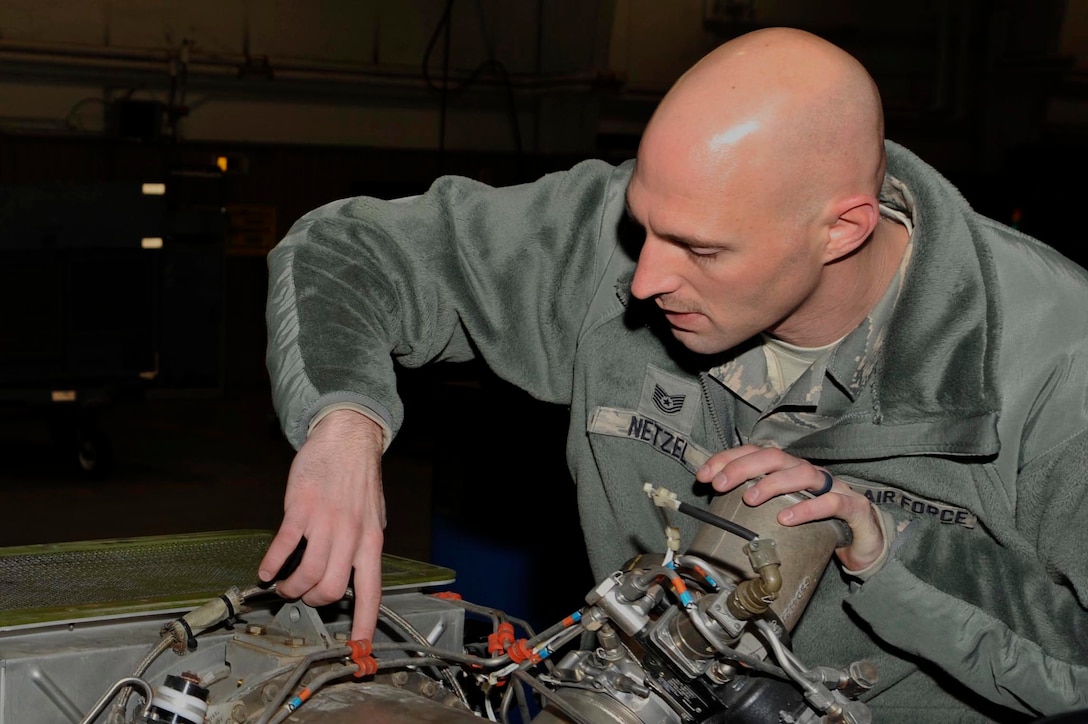 U.S. Air Force Tech. Sgt. John Netzel, 20th Equipment Maintenance Squadron (EMS) aerospace ground equipment (AGE) noncommissioned officer in charge, right, explains how to repair a 60-turbine generator at Shaw Air Force Base, S.C., Jan. 18, 2018.