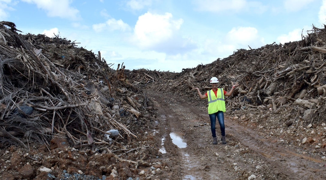 U.S. Army Corps of Engineers Debris Mission Manager Jasmine Smith stands among the mountain of vegetative debris that has been collected at one of 33 sites across Puerto Rico in support of Hurricane Maria recovery efforts.