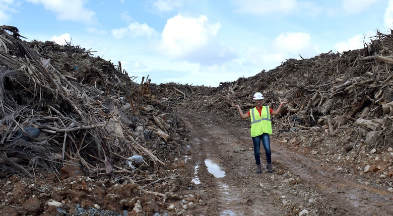 U.S. Army Corps of Engineers Debris Mission Manager Jasmine Smith stands among the mountain of vegetative debris that has been collected at one of 33 sites across Puerto Rico in support of Hurricane Maria recovery efforts.