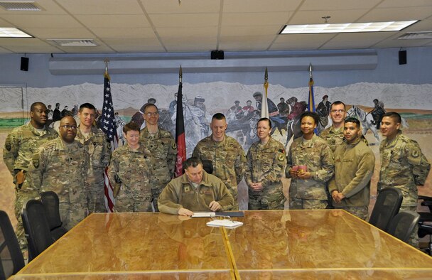 Brig. Gen. Craig Baker, 455th Air Expeditionary Wing commander, signs the Biomedical Science Corps proclamation Jan. 22, 2018 at Bagram Airfield, Afghanistan.